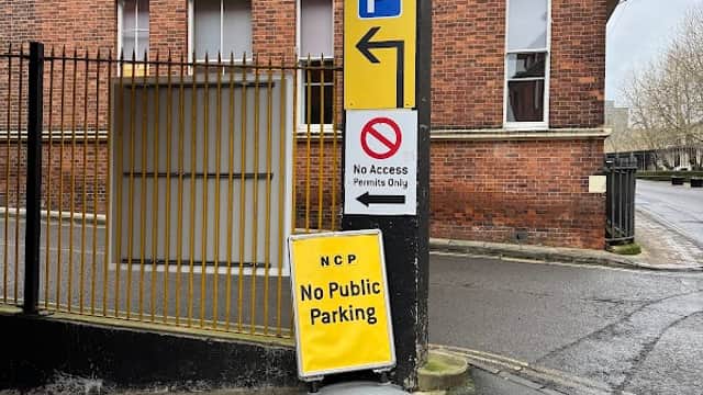 Signage indicating parking rules at NCP Tanner Row, with a brick building and a no public parking sign visible.