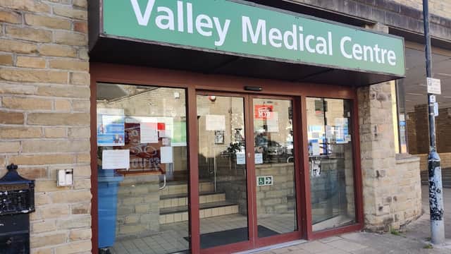 Entrance of Valley Medical Centre with glass doors, stone walls, and signage in green.