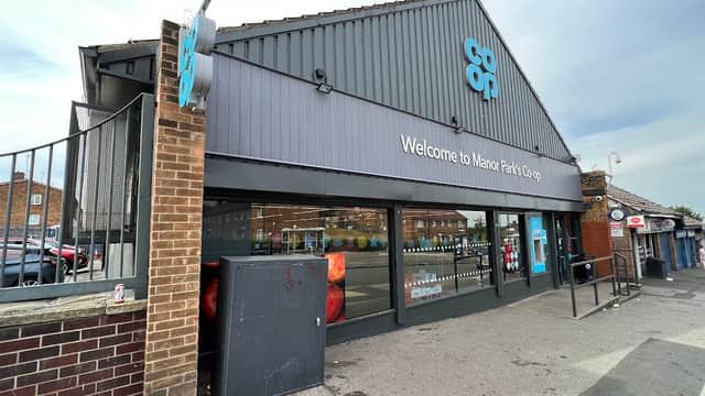Welcome to Manor Park Co-op, featuring a modern storefront and large windows displaying products inside.