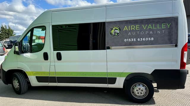 Aire Valley Autopaint Ltd van parked outside, featuring a logo, contact info, and a clear blue sky in the background.