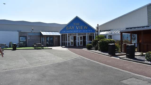 The Bay View Entertainment Centre entrance at Haven Holiday Park, with a clear sky and landscaped pathways.