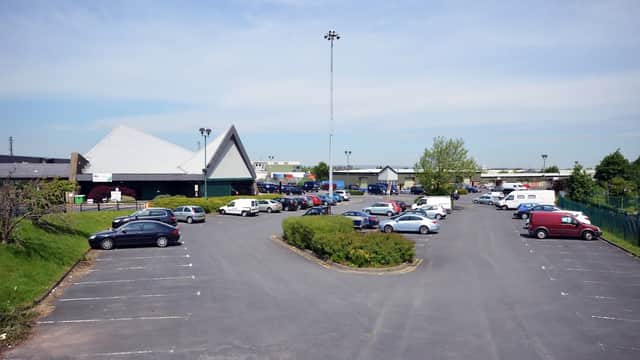 Self-storage facility in Dudley Hill with a spacious parking lot filled with various parked vehicles and greenery.