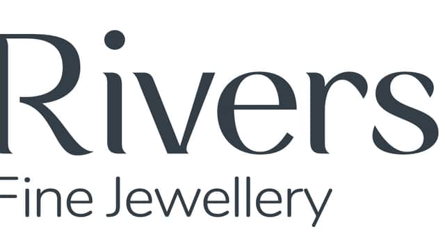 Stylized logo for Riverstones Fine Jewellery featuring elegant typography in purple and grey.