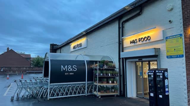 M&S Foodhall entrance with shopping carts and potted plants, under a cloudy evening sky in Beverley, Yorkshire.