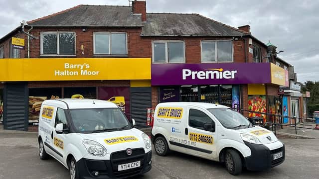 Two white vans parked outside a corner shop with yellow and purple signage reading "Barry's Halton Moor" and "Premier."