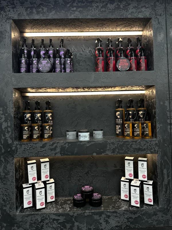 Shelves displaying various grooming products, including sprays, creams, and pomades in stylish packaging.