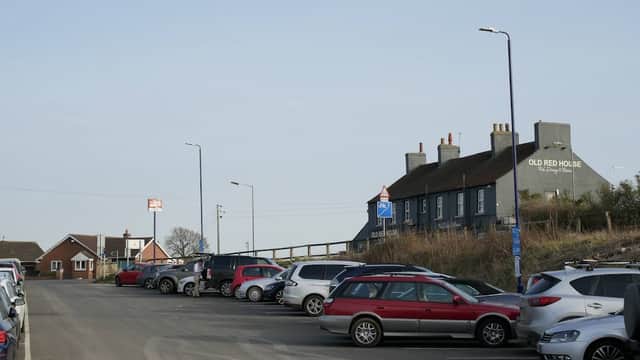 APCOA Parking at Thirsk Station with parked cars and the Old Red House pub in the background.