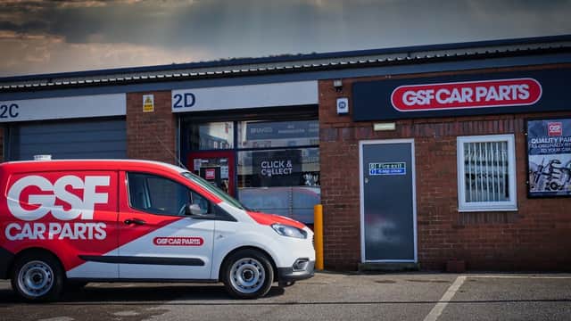 GSF Car Parts building with a red delivery van parked outside, showcasing the company logo and signage.