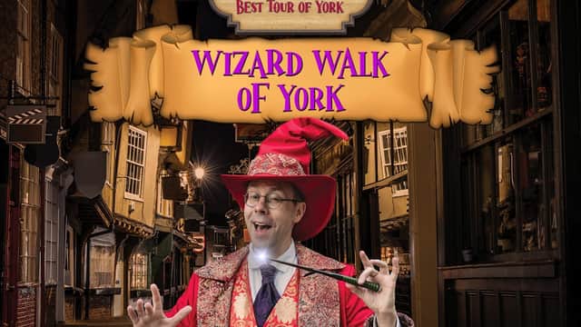 Wizard Walk of York award banner with a wizard in a red hat and robe, holding a wand in a historic street setting.