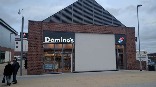 Domino's Pizza storefront in Catterick Garrison, featuring a modern design and large windows.