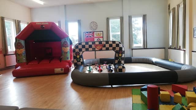 Bright indoor space featuring a bouncy castle, a racing track, and colorful play blocks in Thurcroft, Yorkshire.