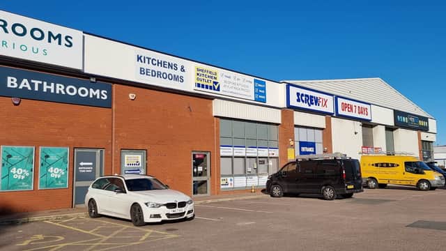 Screwfix store in Hillsborough, Sheffield, with parked vehicles and signage for kitchens, bathrooms, and trade accounts.