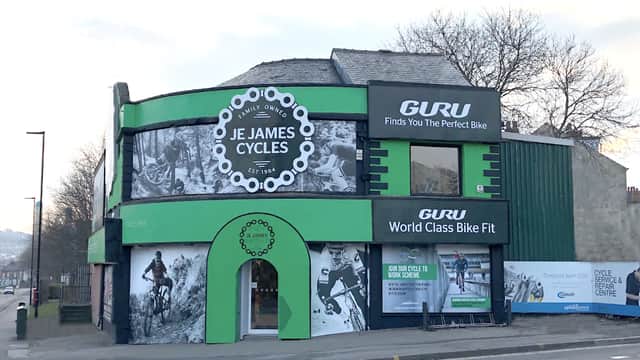 Green and black bike shop exterior with large signage for "J E James Cycles" and "GURU" in Sheffield, Yorkshire.