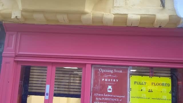 Bright pink storefront with large windows displaying "FULLY FLOORED" and "Opening Soon" signs in York, Yorkshire.