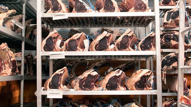Shelves filled with aged beef cuts, neatly arranged in a meat storage area at R&J Yorkshire's Finest Farmers & Butchers.