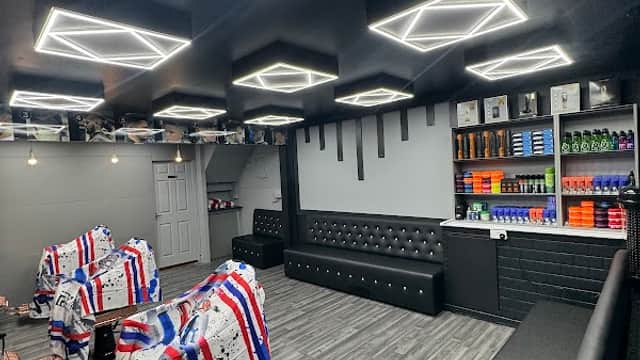 Modern car park interior with sleek black seating, geometric ceiling lights, and organized product displays.