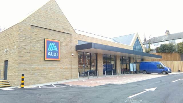 ALDI store in Chapel Allerton, Yorkshire, featuring a stone facade and large glass entrance, with a blue delivery van parked outside.