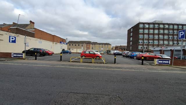 Brunswick Street Car Park with multiple parked cars and a sign indicating parking spaces, under a cloudy sky.