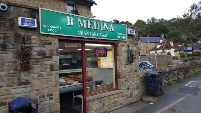 Green sign with "B Medina Asian Takeaway," stone building, open sign, takeaway window, nearby residential area.