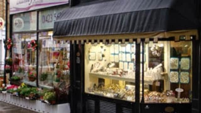 Jewellery shop with display window showcasing rings and necklaces, next to a florist in Harrogate, Yorkshire.