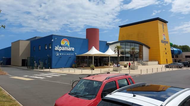 Alpamare Car Park in Scarborough, featuring a colorful building and a Pay & Display area with parked cars.