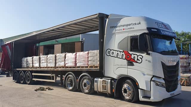A large truck unloading pallets at Jewson Rotherham, an ironmongers in Eastwood, Yorkshire.