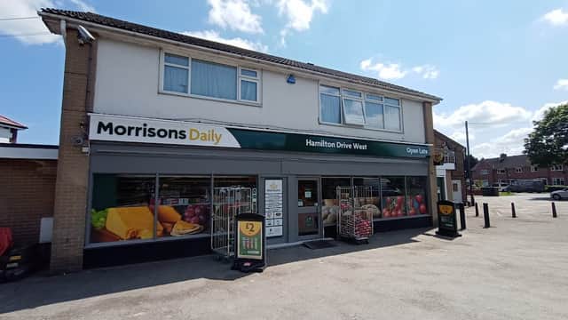 Morrisons Daily storefront with large windows, colorful produce displays, and an "Open Late" sign in York, Yorkshire.