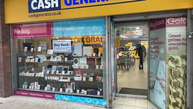 Storefront of Cash Generator in Rotherham, showcasing electronics for buy and sell, with promotional signs and displays.