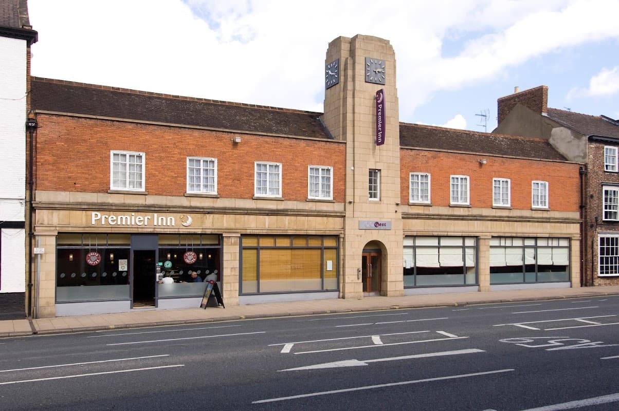 Premier Inn hotel in York with a brick façade, large windows, and a prominent clock tower.