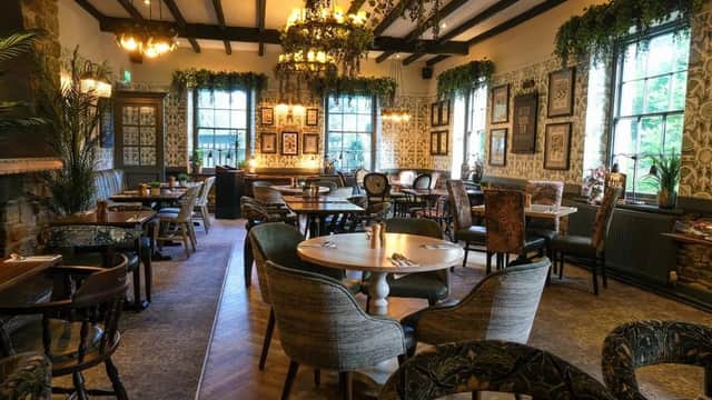 Cozy bar interior with wooden beams, floral decor, vintage furniture, and warm lighting in Wentworth, Yorkshire.