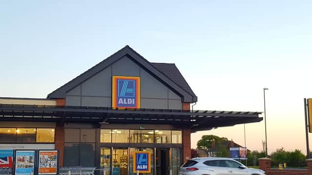 ALDI store in Sowerby, North Yorkshire, featuring a modern facade and parked car in the foreground at dusk.