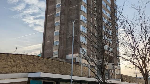 Civic Centre Car Park with a multi-story building, parked cars, and trees in Huddersfield, Yorkshire.
