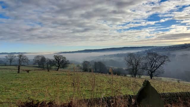 Mist-covered fields with bare trees under a cloudy sky, showcasing the rural landscape of Laycock, Yorkshire.