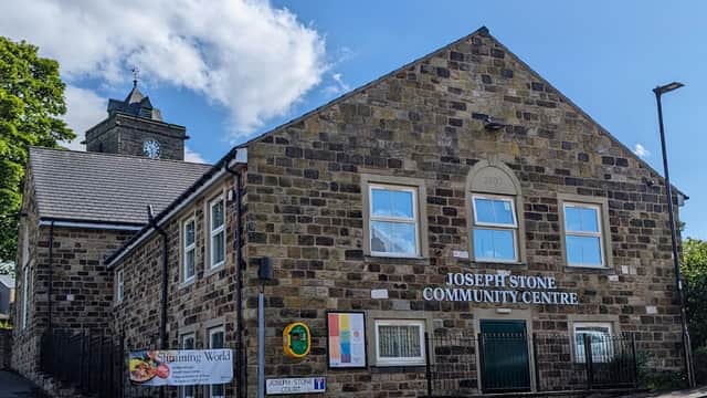 Joseph Stone Community Centre, a stone building with a clock tower, signage, and surrounding greenery in Mosborough.