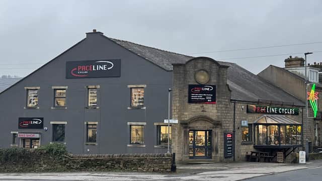 Paceline Cycles shopfront featuring a bike shop and café, with signage and a large window display in Cross Hills, Yorkshire.