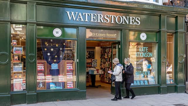 Waterstones bookstore in Harrogate, featuring a green facade, welcoming entrance, and display of books in windows.