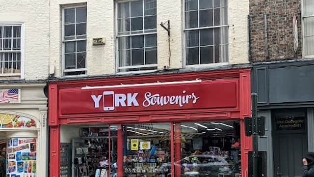 Bright red storefront of "York Souvenir's" gift shop, featuring various souvenirs and memorabilia in the display windows.