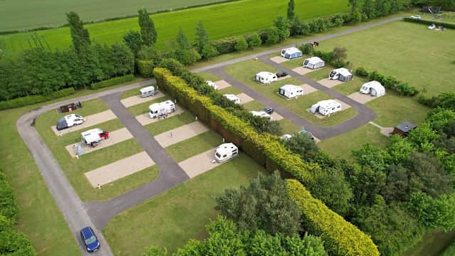 Aerial view of Robin Hood Caravan Park featuring neatly arranged caravans and green fields in Slingsby, Yorkshire.