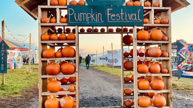 Wooden archway filled with pumpkins, leading to Spilman's Pumpkin Festival at a farm in Sessay, Yorkshire.