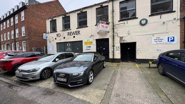 NCP Street Parking at Toft Green, featuring parked cars and a building with "TO LET" signage.