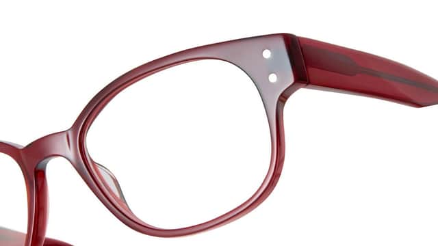 Red eyeglasses with a stylish frame, showcasing a modern design and clear lenses.