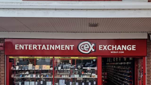 CeX store front featuring a bright red sign, displaying "Entertainment Exchange" and various electronic items in the window.