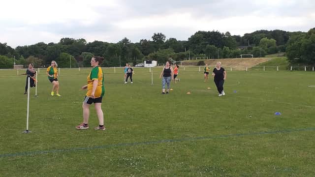 Participants engaged in a cricket practice session on a grassy field at Thornhill Cricket & Bowling Club.