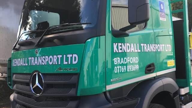Green Mercedes truck with "KENDALL TRANSPORT LTD" and "BRADFORD" signage, parked in a yard.