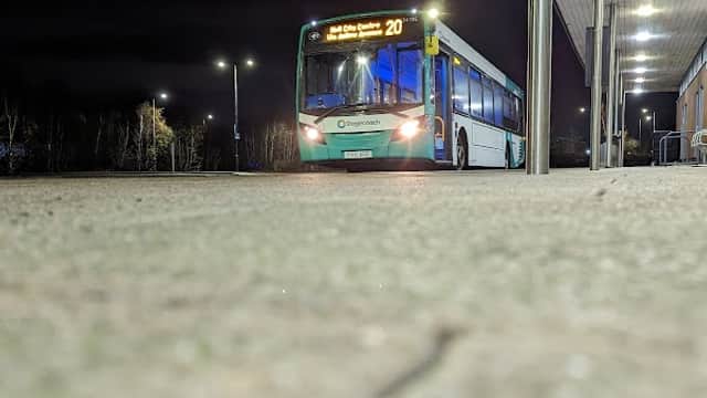 A bus at night at Priory Park Park and Ride in Hull, with lighting and a modern shelter visible.