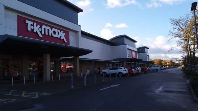 TK Maxx storefront with a parking area, blue sky, and scattered clouds in Eckington, Yorkshire.