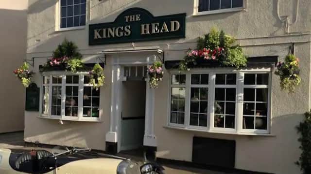The Kings Head restaurant with flower baskets, large windows, and a vintage car parked outside in Pollington, Yorkshire.