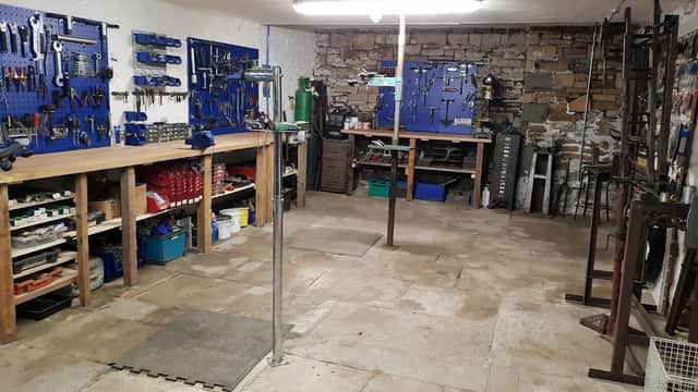 Bike workshop with tool storage, workbenches, and a clean, organized floor in Sheffield, Yorkshire.