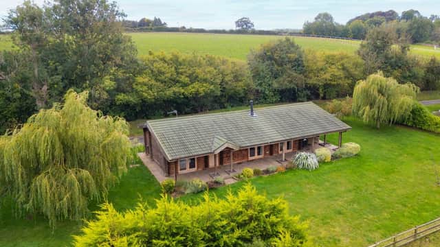 Lodge surrounded by lush greenery and trees, set in a tranquil rural landscape in Constable Burton, Yorkshire.
