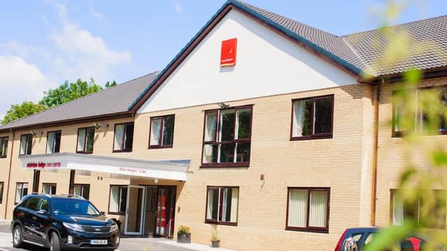 Stainton Lodge Care Centre with a modern facade, parking area, and clear blue sky in Stainton, Yorkshire.